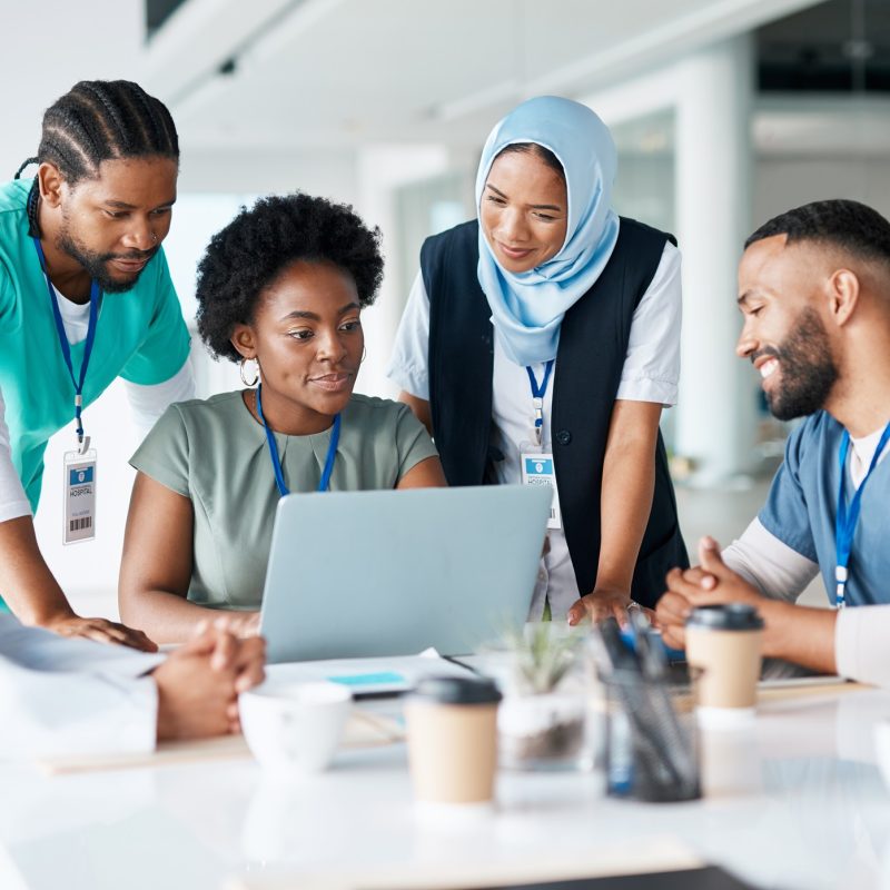 Teamwork, planning and meeting with doctors and laptop for medical, review and healthcare. Medicine, technology and internet with group of people for collaboration, diversity and support in hospital