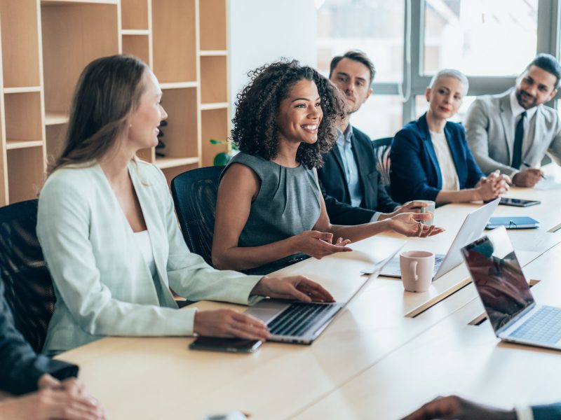 Multiethnic  group of businesspeople sitting together and having a meeting in the office.